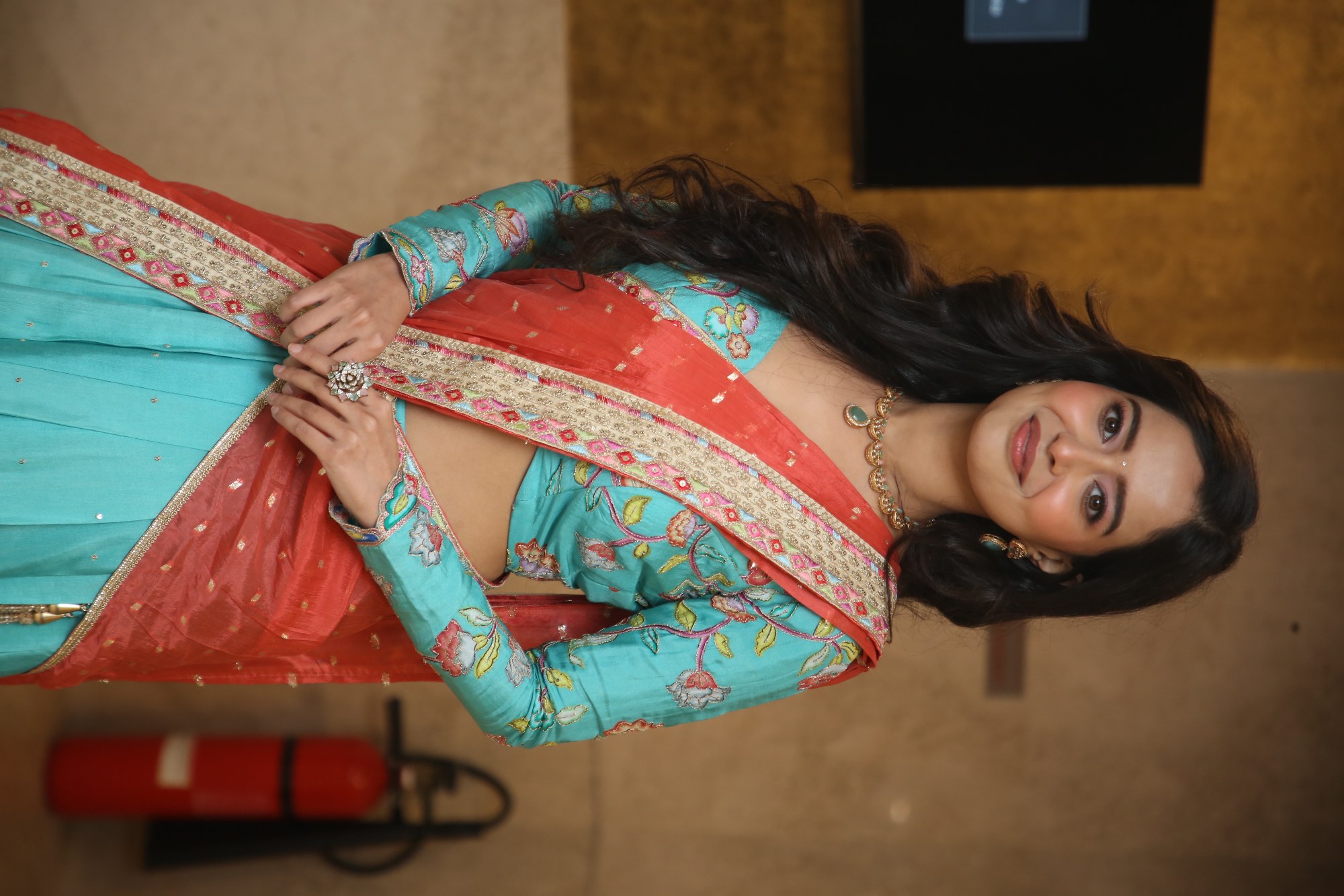 Megna Mukherjee smiling in vibrant trendy saree