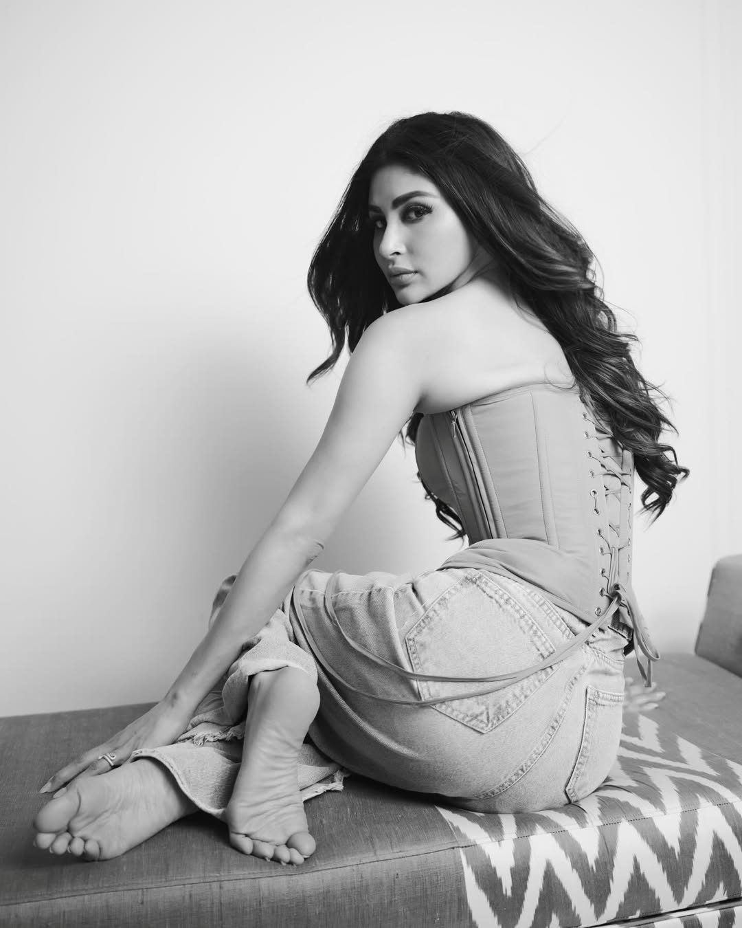 Mouni Roy glamorous style against plain wall