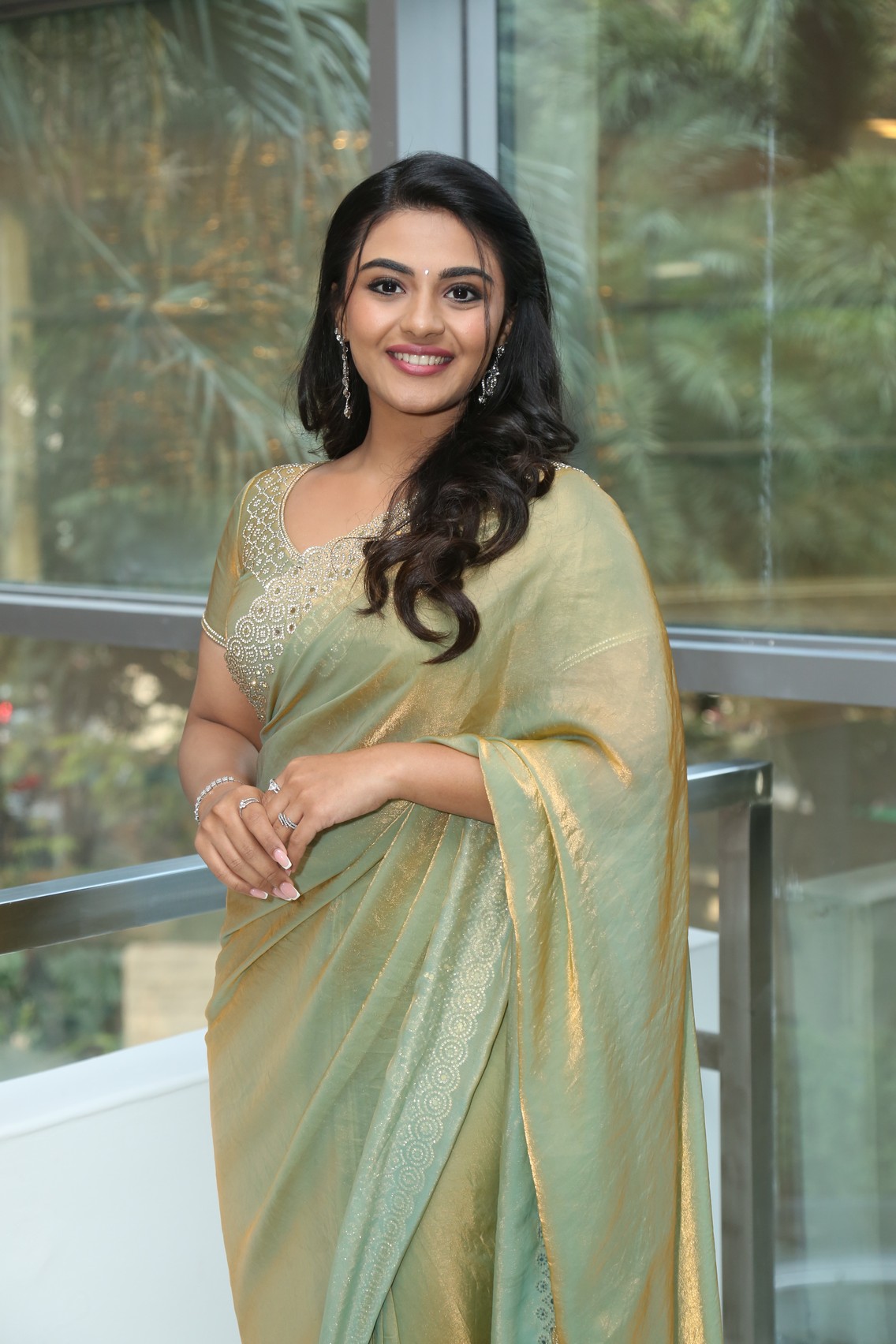 Nayan Sarika shimmering golden green saree