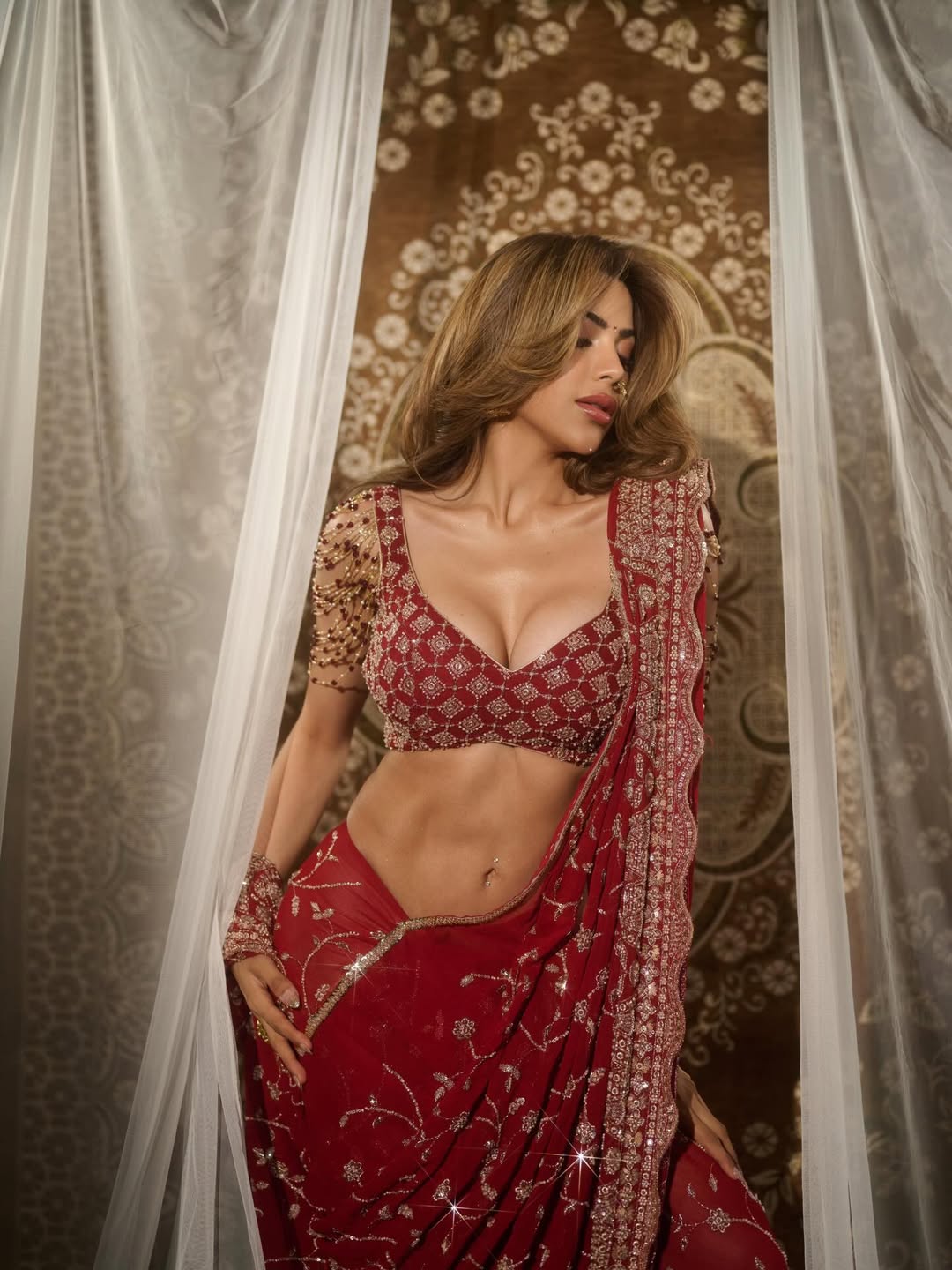 Nikki Tamboli sparkling red bold ethnic style