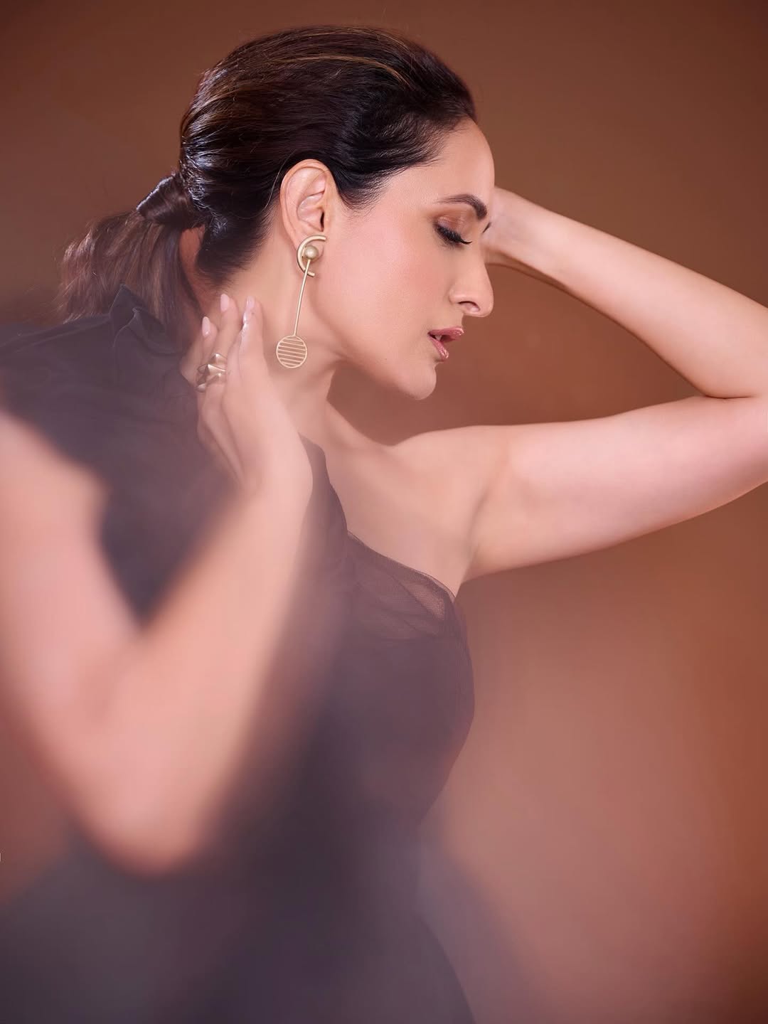 Pragya Jaiswal posing in dramatic black dress