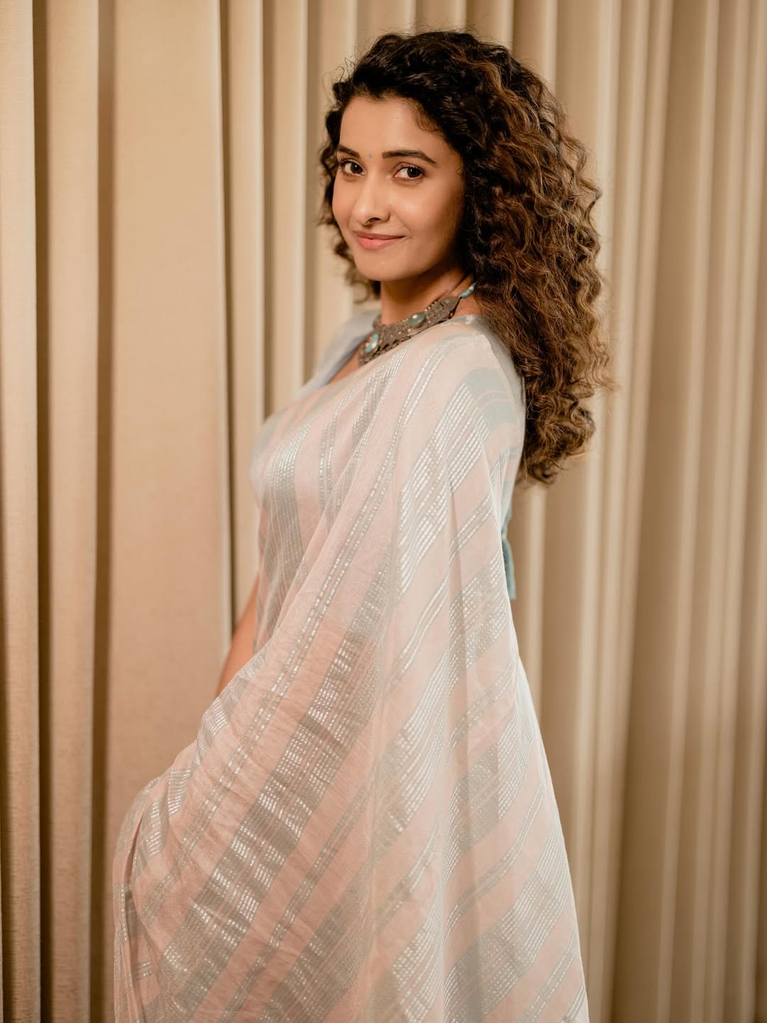 Priya curly hair elegant saree look