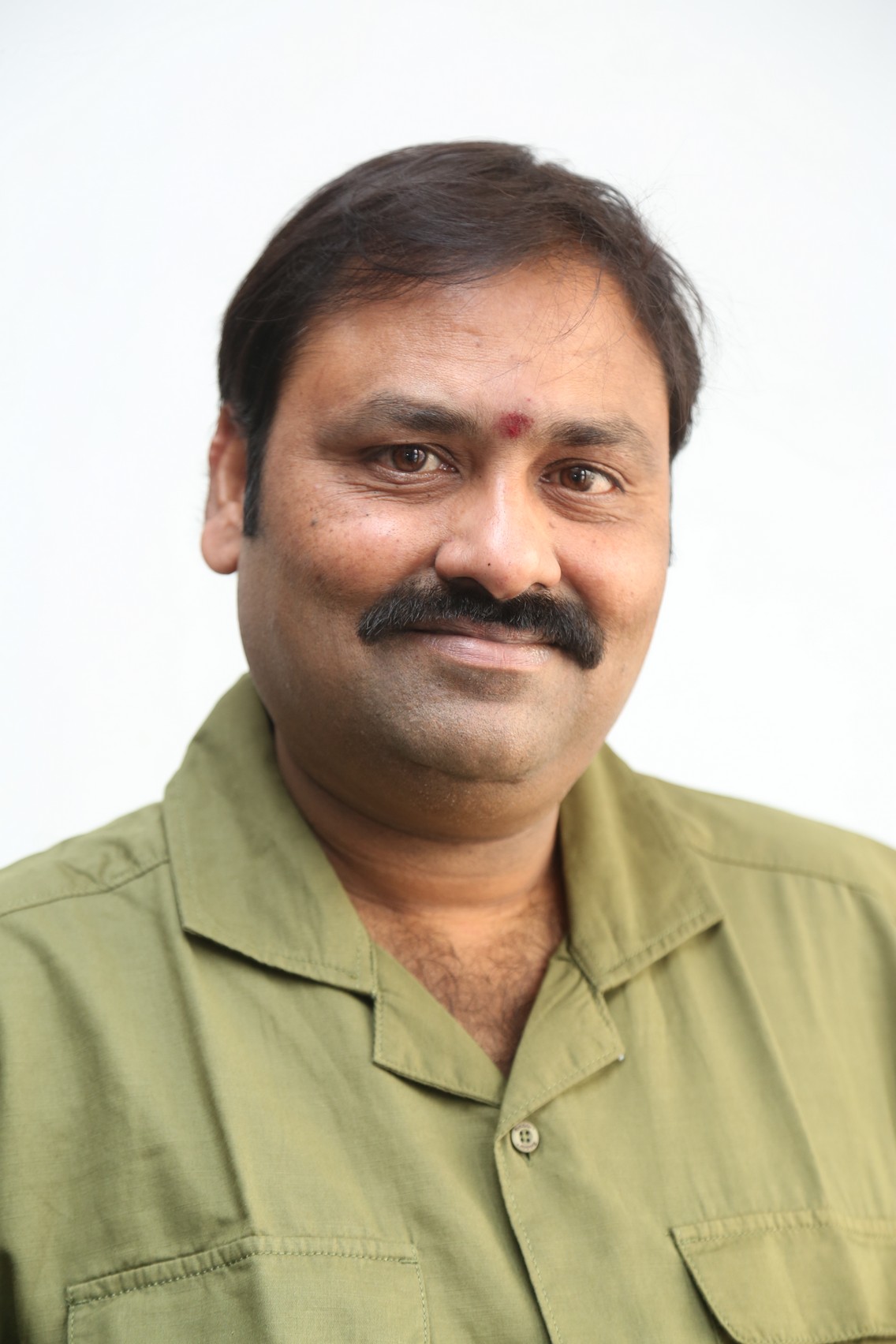 Suman Babu polished charm in olive green shirt