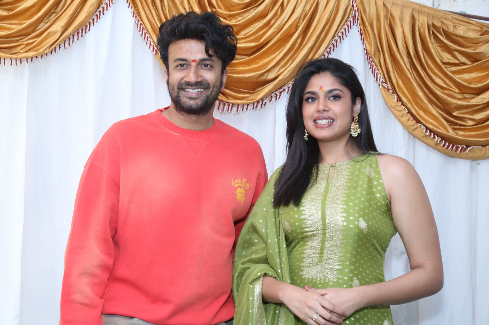 Satyadev and Faria Abdullah posing at film opening