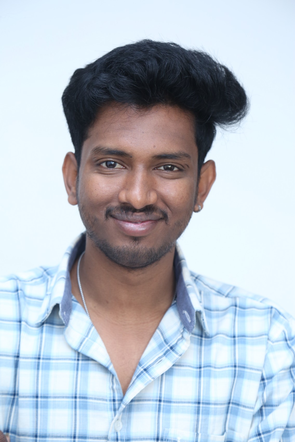 Vinay Ratnam smiling sharp in casual style