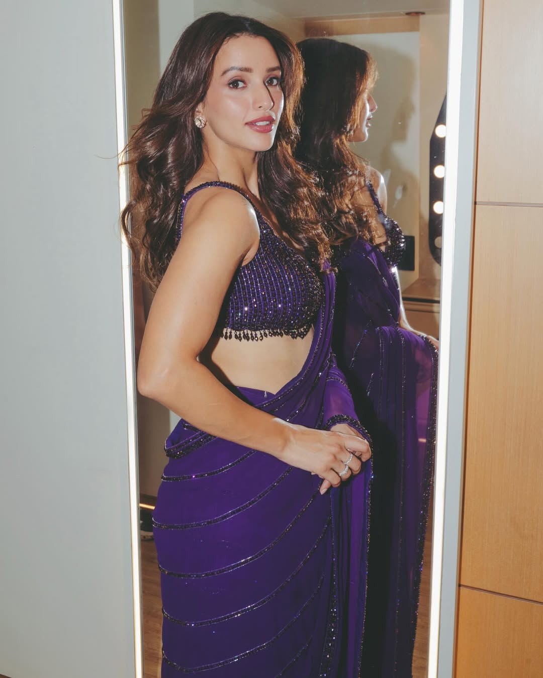 Tripti Dimri blending traditional Indian saree style with bold contemporary fashion.