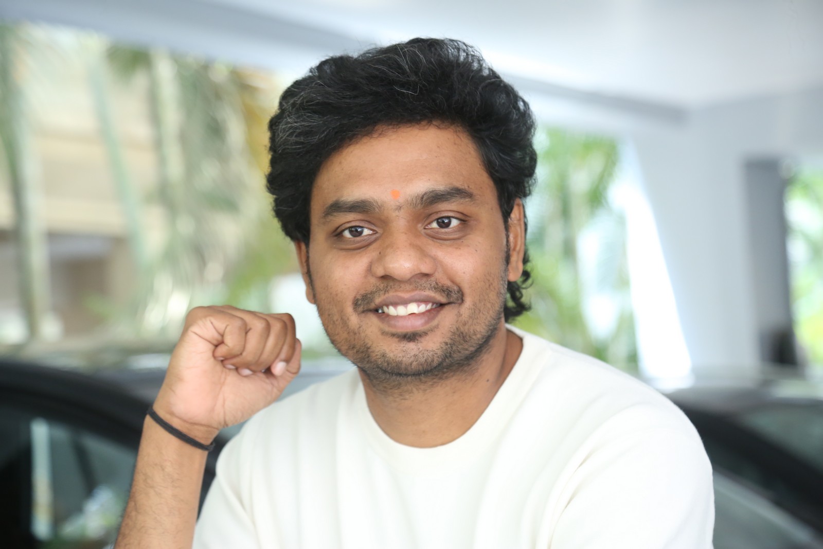 Abhilash Reddy confident smile in classic white tee look