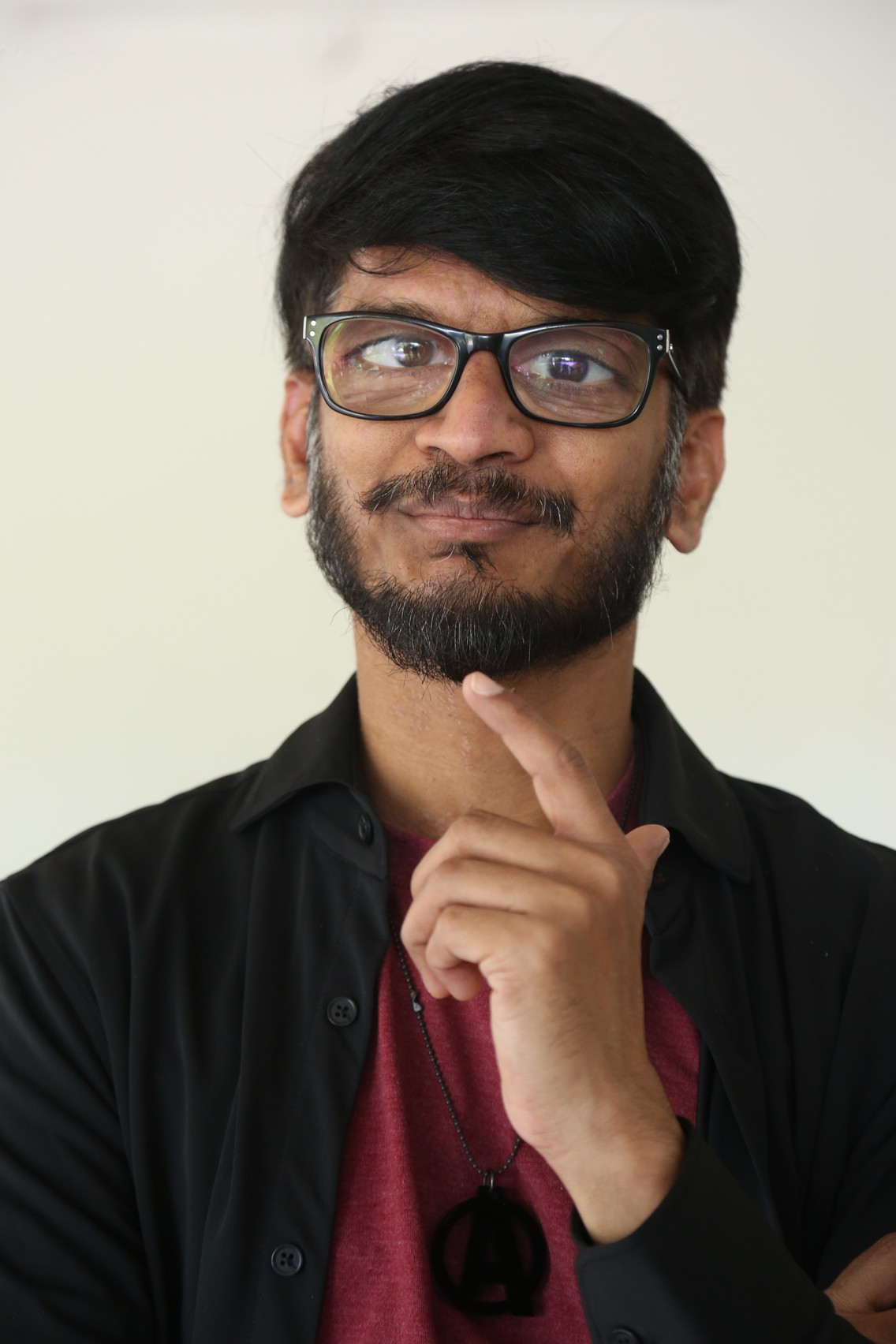 Ananth Sriram thoughtful pose with stylish glasses look