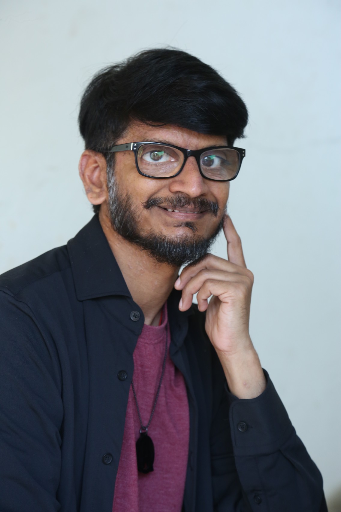 Ananth Sriram elegant style with glasses and formal attire