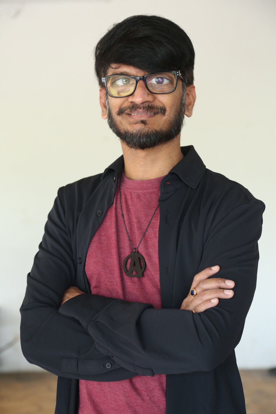 Ananth Sriram stylish black outfit with signature glasses