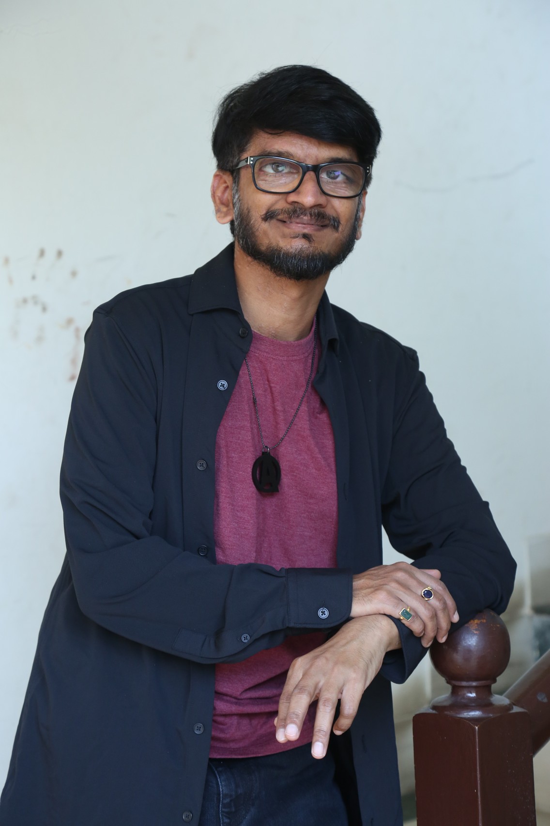 Ananth Sriram fashionable look with glasses and confident expression