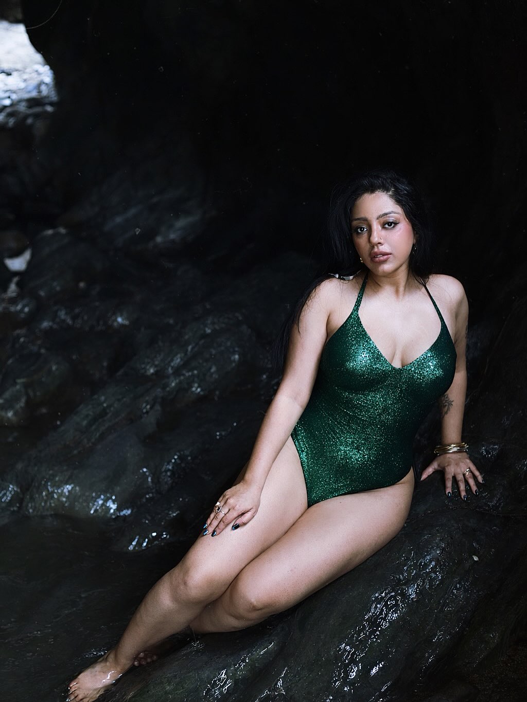 Deviyani Sharma stunning in green swimwear against rocky natural backdrop