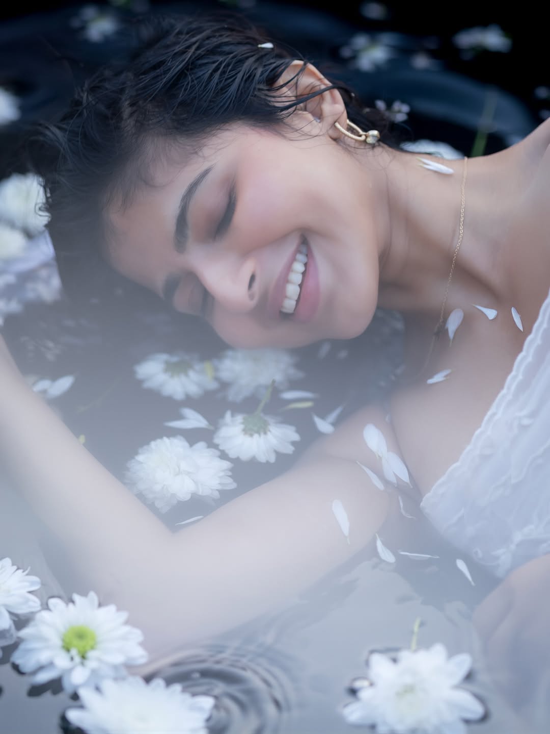 Iswarya Menon graceful poolside portrait with floral backdrop