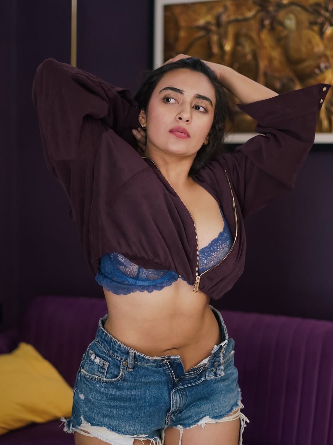 Jinal Joshi wearing blue lace bralette, maroon jacket and distressed denim shorts stylish pose