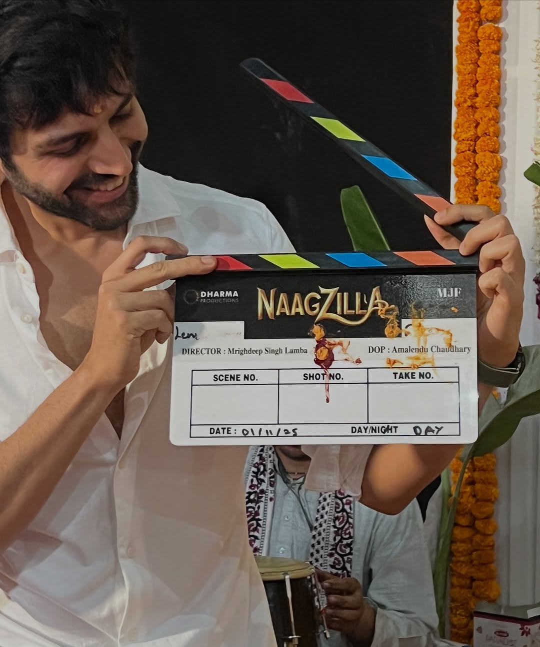 Kartik Aaryan holding Naagzilla clapboard behind the scenes