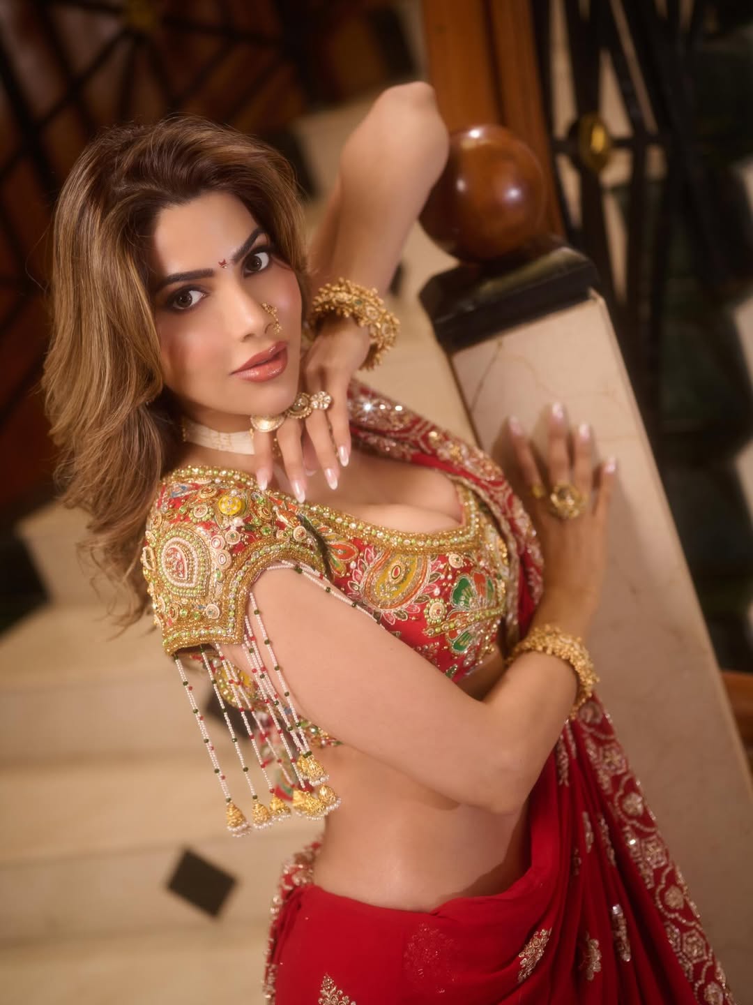 Nikki Tamboli red gold outfit bold glamorous pose