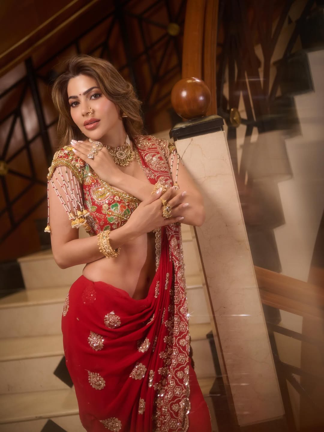 Nikki Tamboli red saree bold jewelry stylish appearance