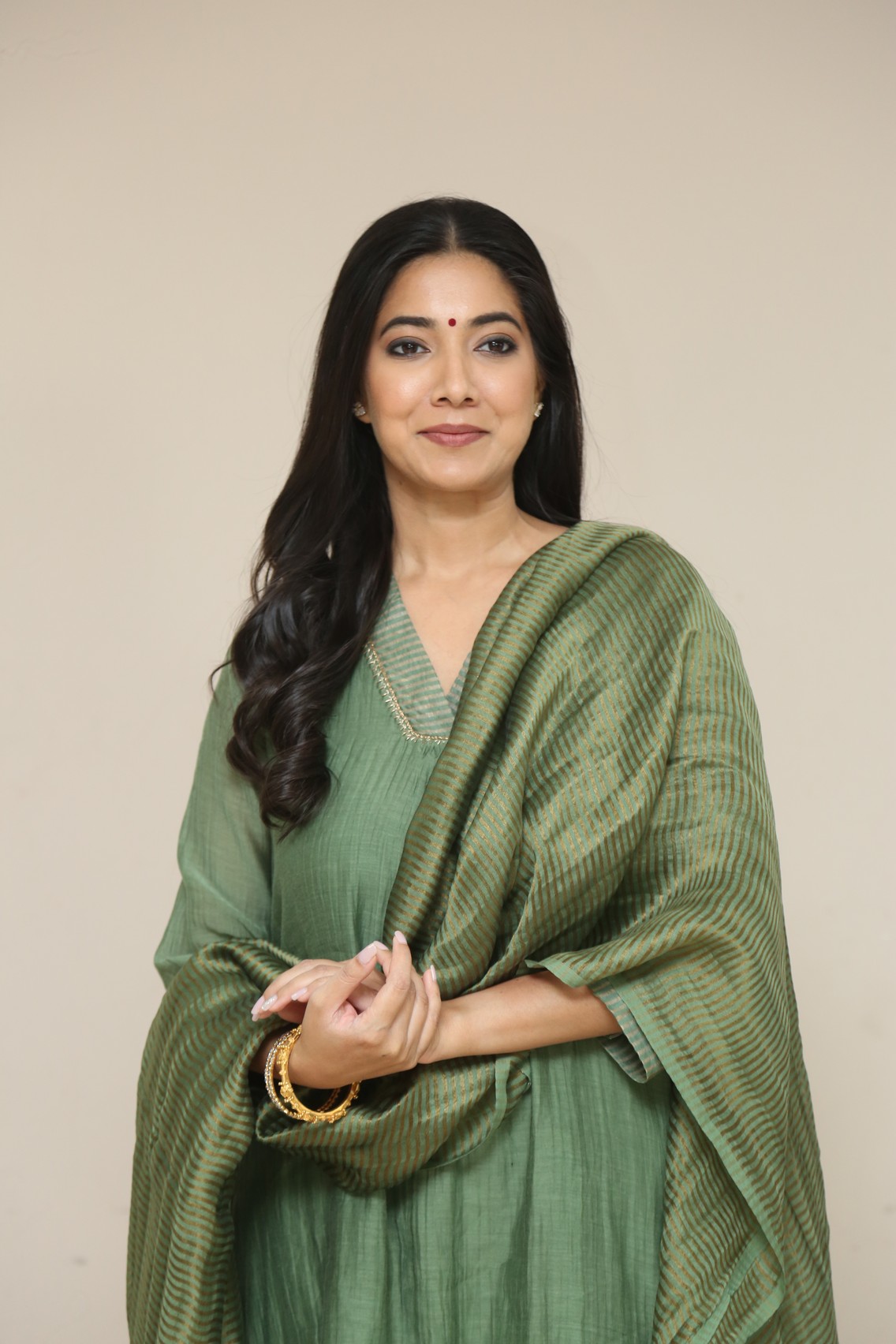 Pooja Sarathkumar graceful smile in green attire