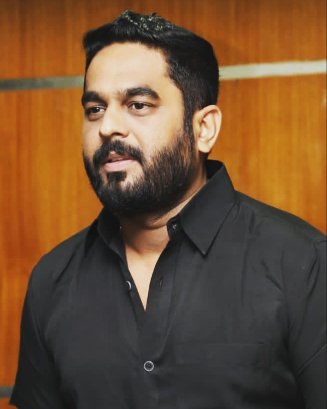 Raghu Bhat sharp suit confident style portrait