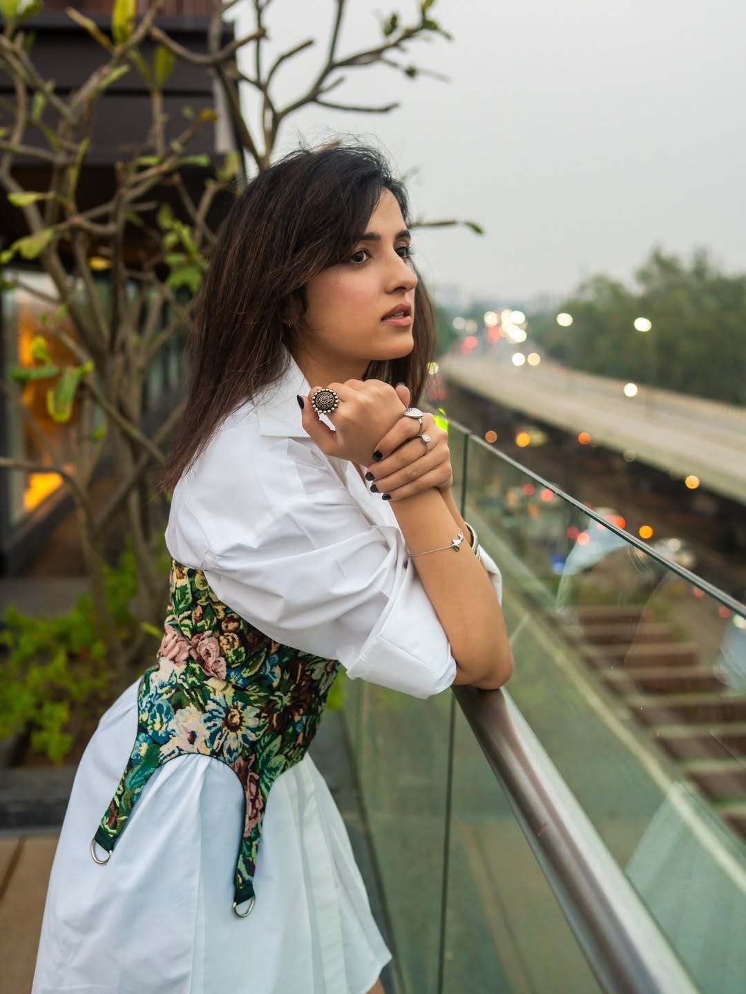 Shirley Setia rooftop fashion white shirt floral accents