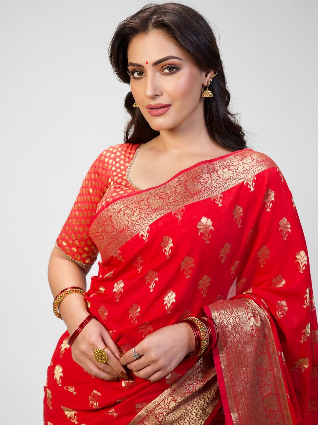 Shivangi Verma red saree gold accents elegant pose