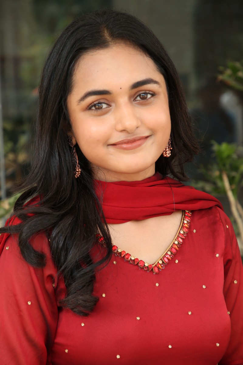 Smeha Manimegalai red outfit radiant smile elegant pose