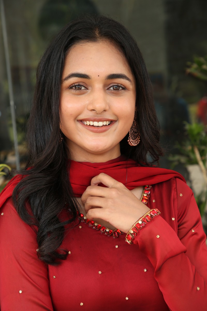 Smeha Manimegalai elegant red attire charming confident pose