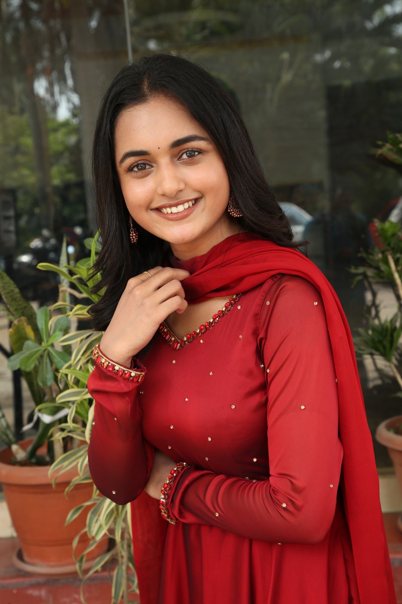 Smeha Manimegalai radiant smile red outfit elegant look