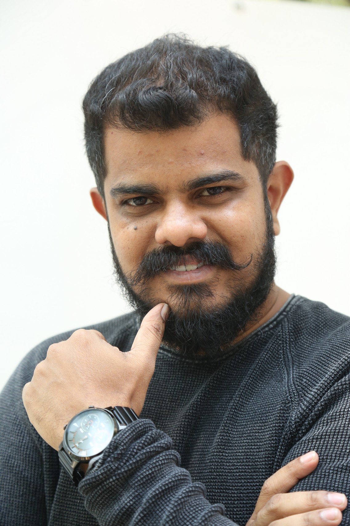 Sudhan sharp look with confident smirk