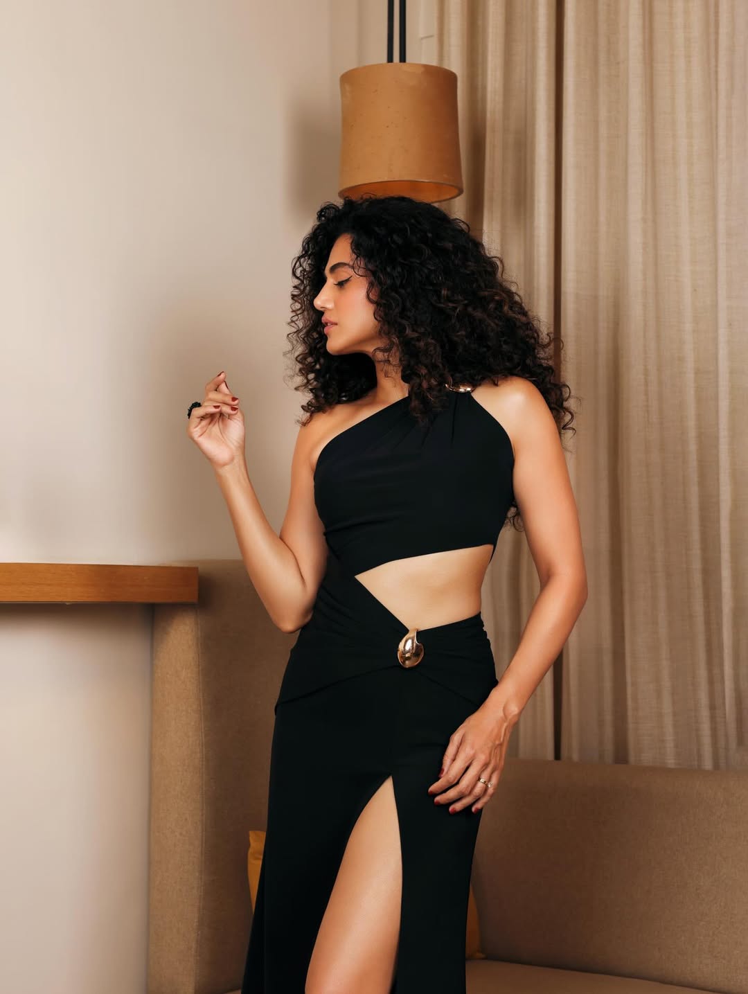 Taapsee Pannu one-shoulder black dress stylish pose