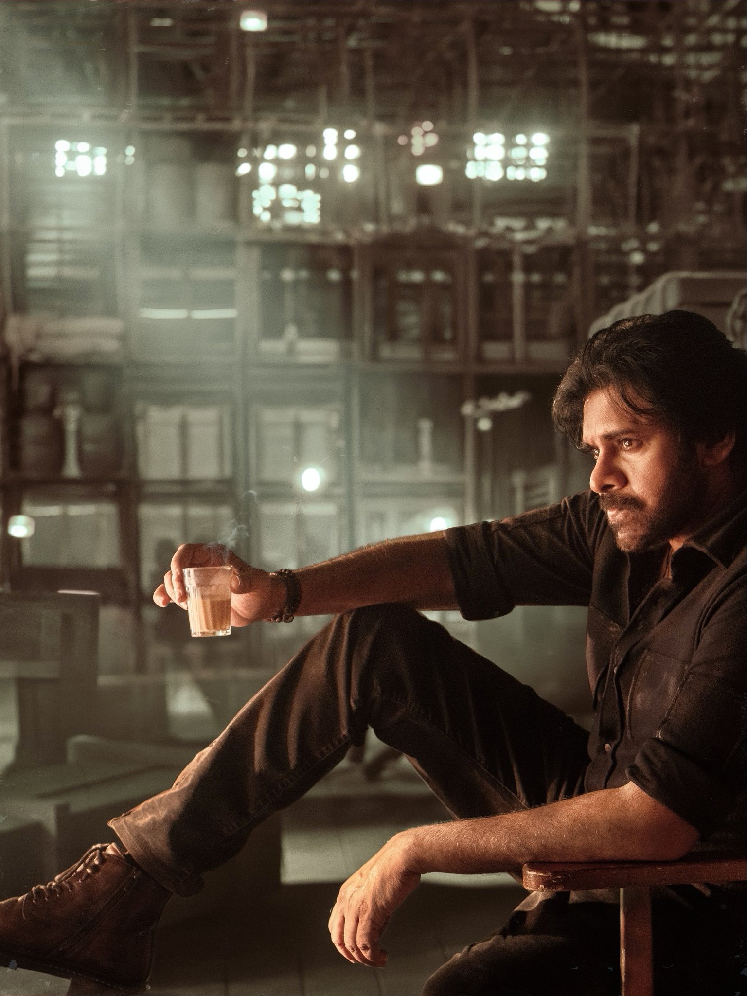 Pawan Kalyan stylish seated pose holding tea cup