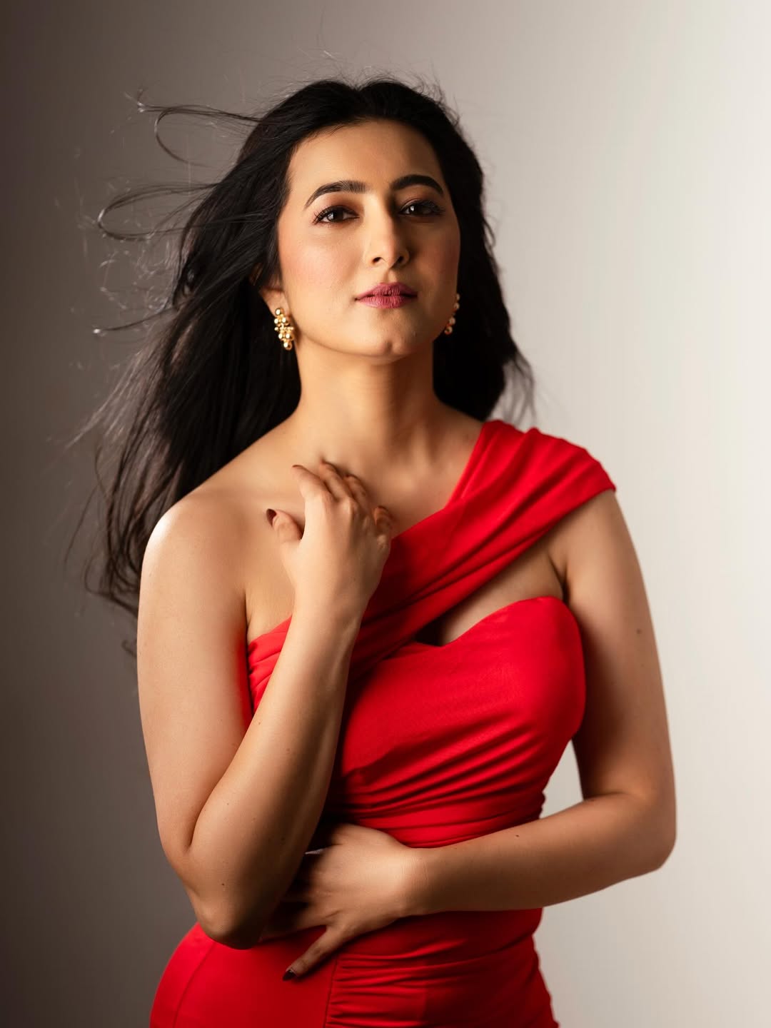 Adhvithi Shetty red outfit dramatic wind effect look