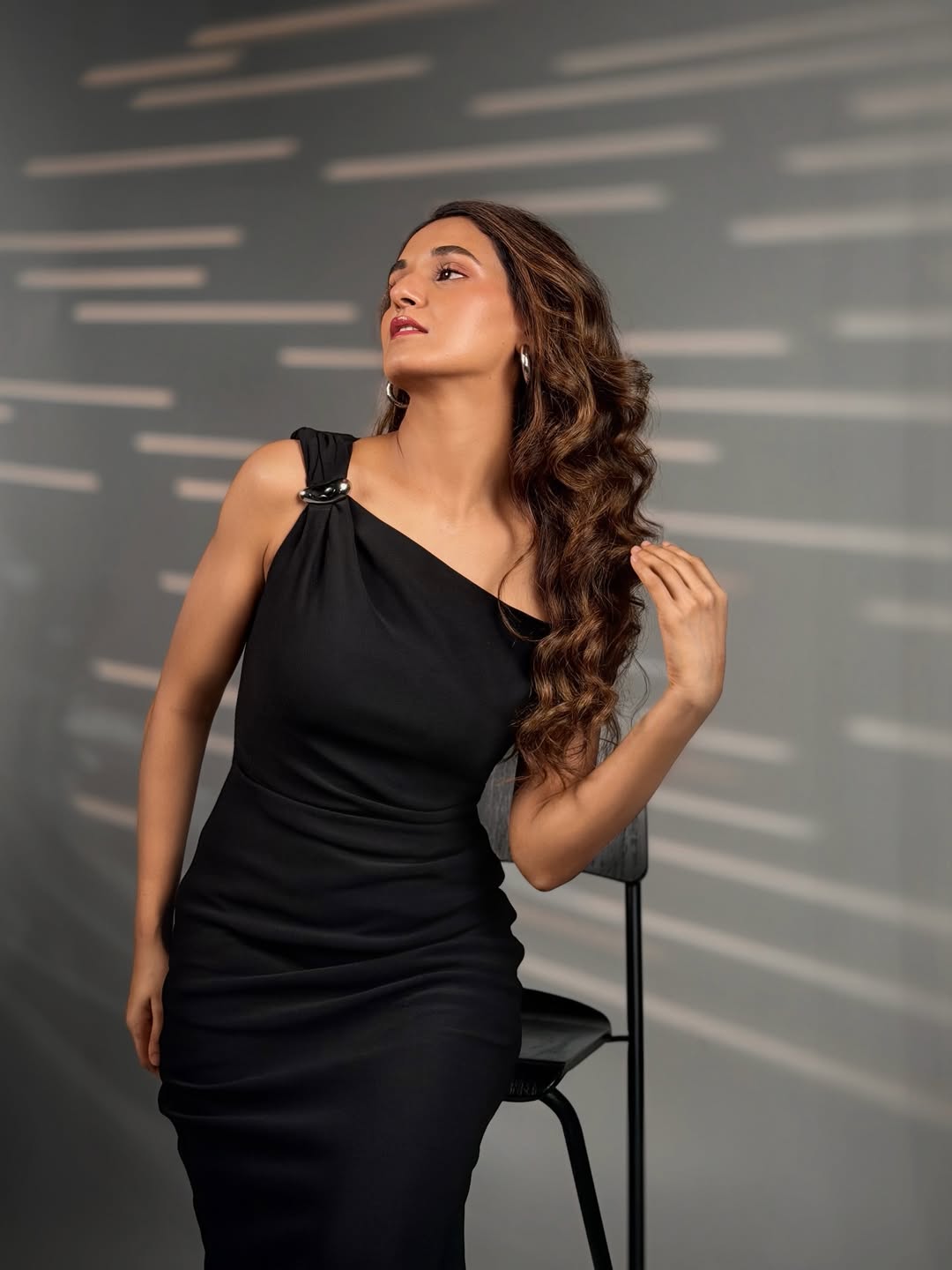 Shakti Mohan wavy hair sleek black dress look