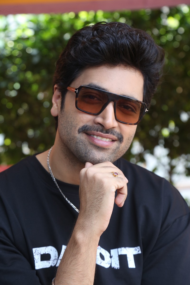 Adivi Sesh confident pose Dacoit tee stylish look