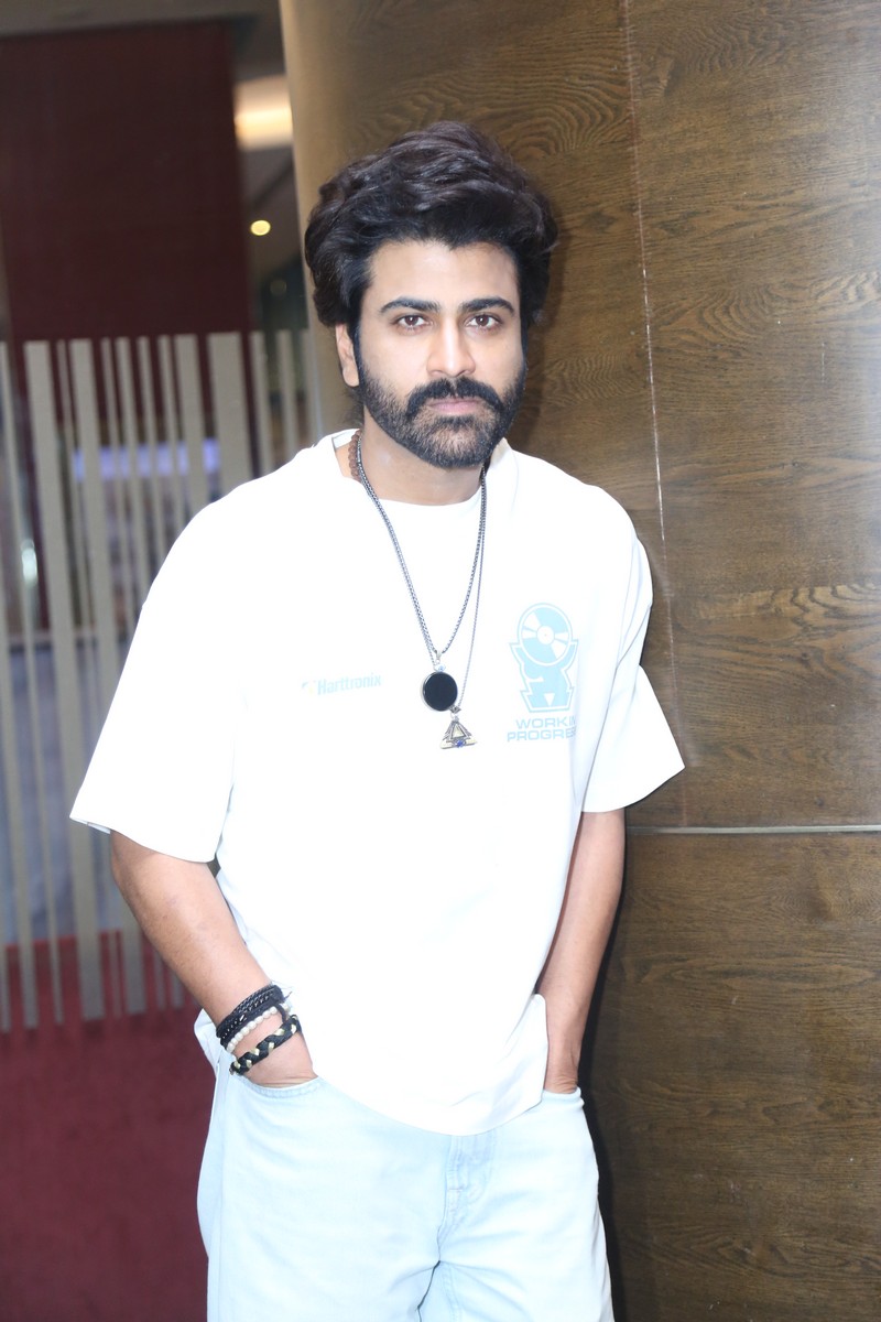 Sharwanand posing for media Biker event