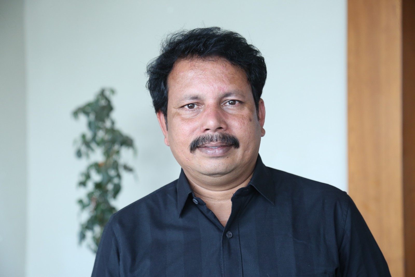 CH Satish Kumar classic black shirt confident professional look