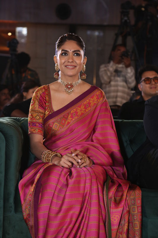 Mrunal Thakur seated at Dacoit event