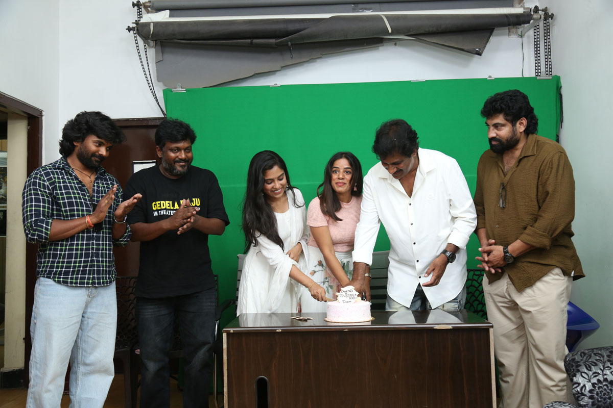 Gedela Raju team cutting celebration cake at event