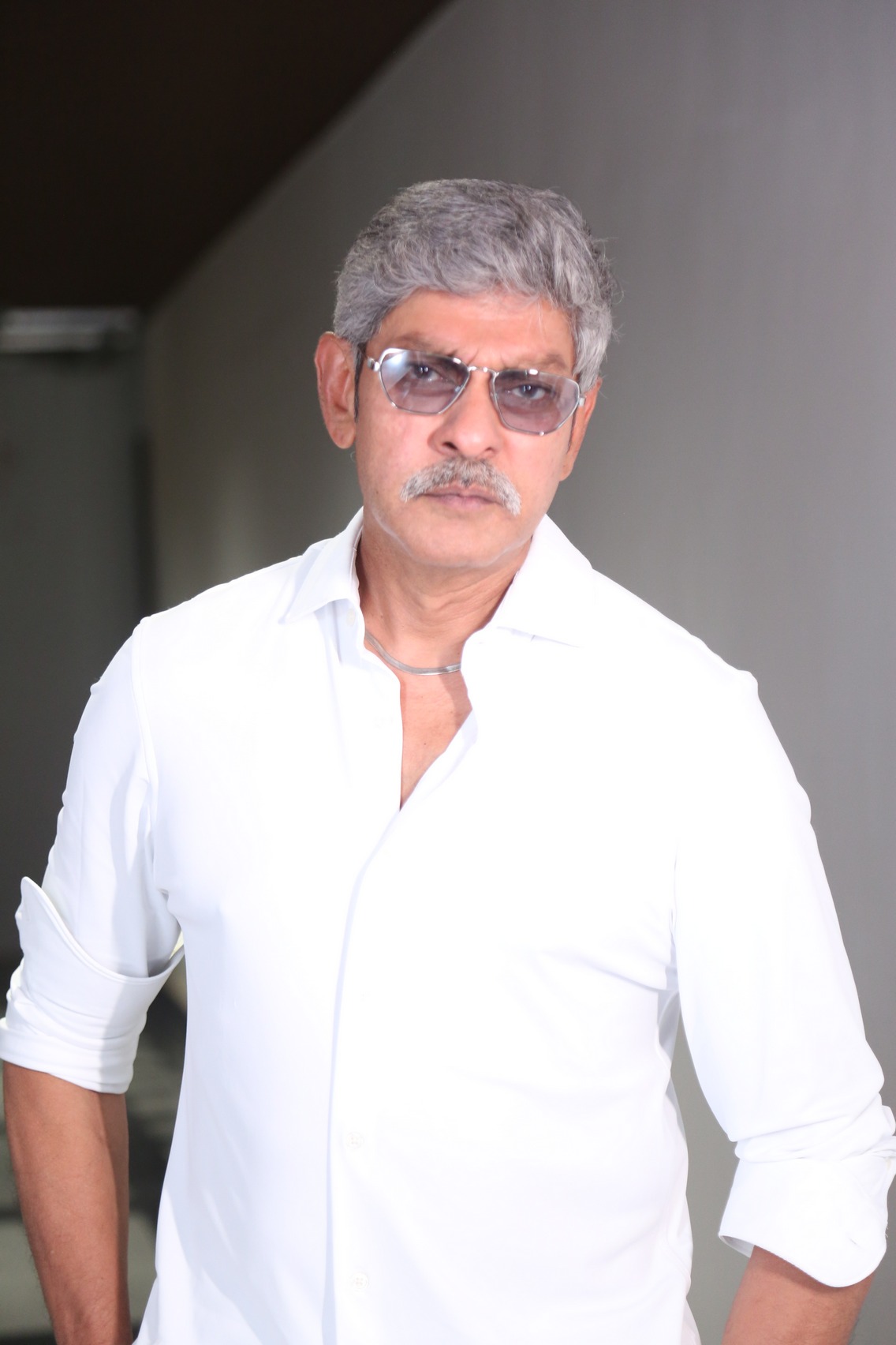 Jagapathi Babu with silver hair in a stylish outfit, exuding mature elegance