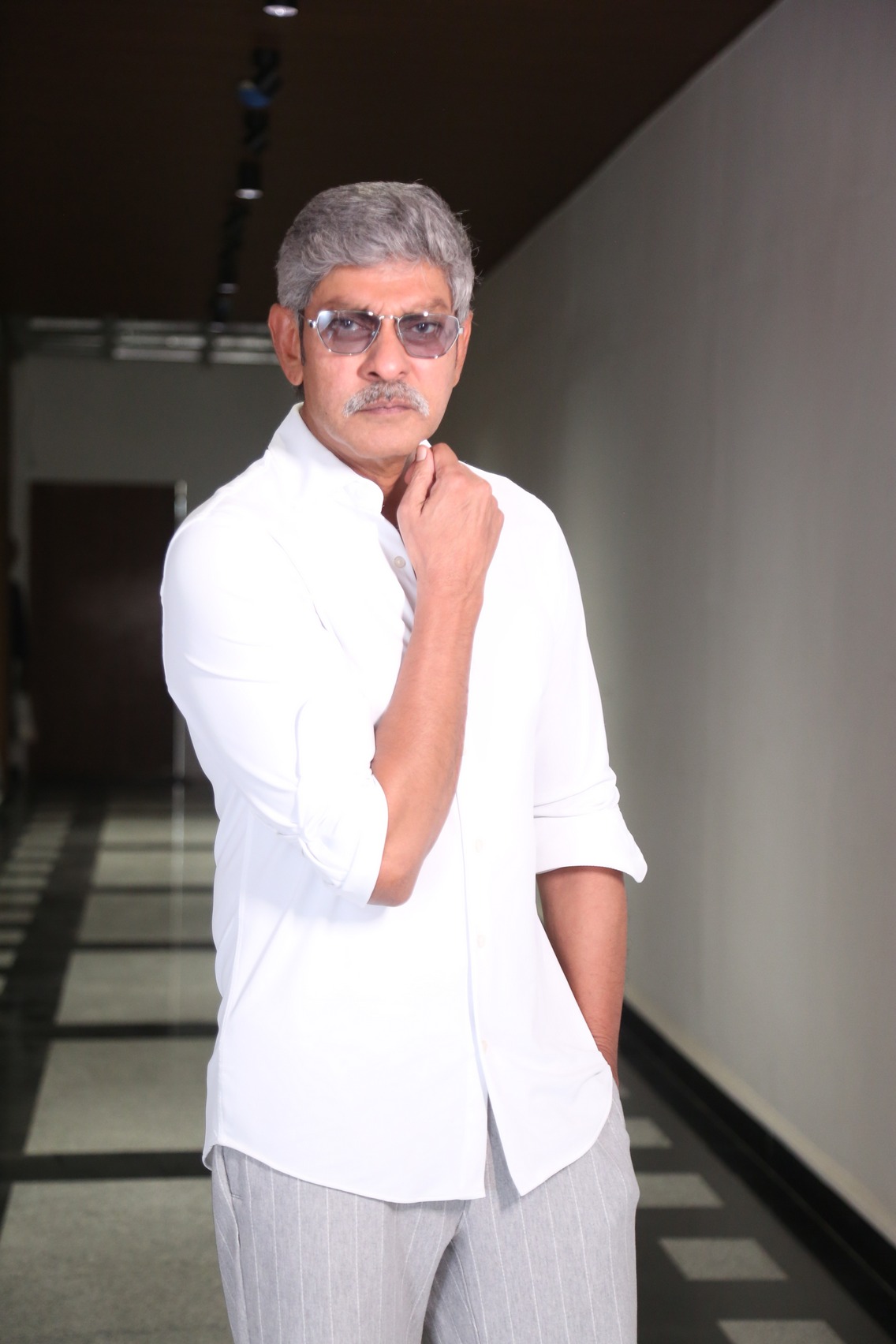Jagapathi Babu wearing a white shirt highlighting his silver hair and composed look