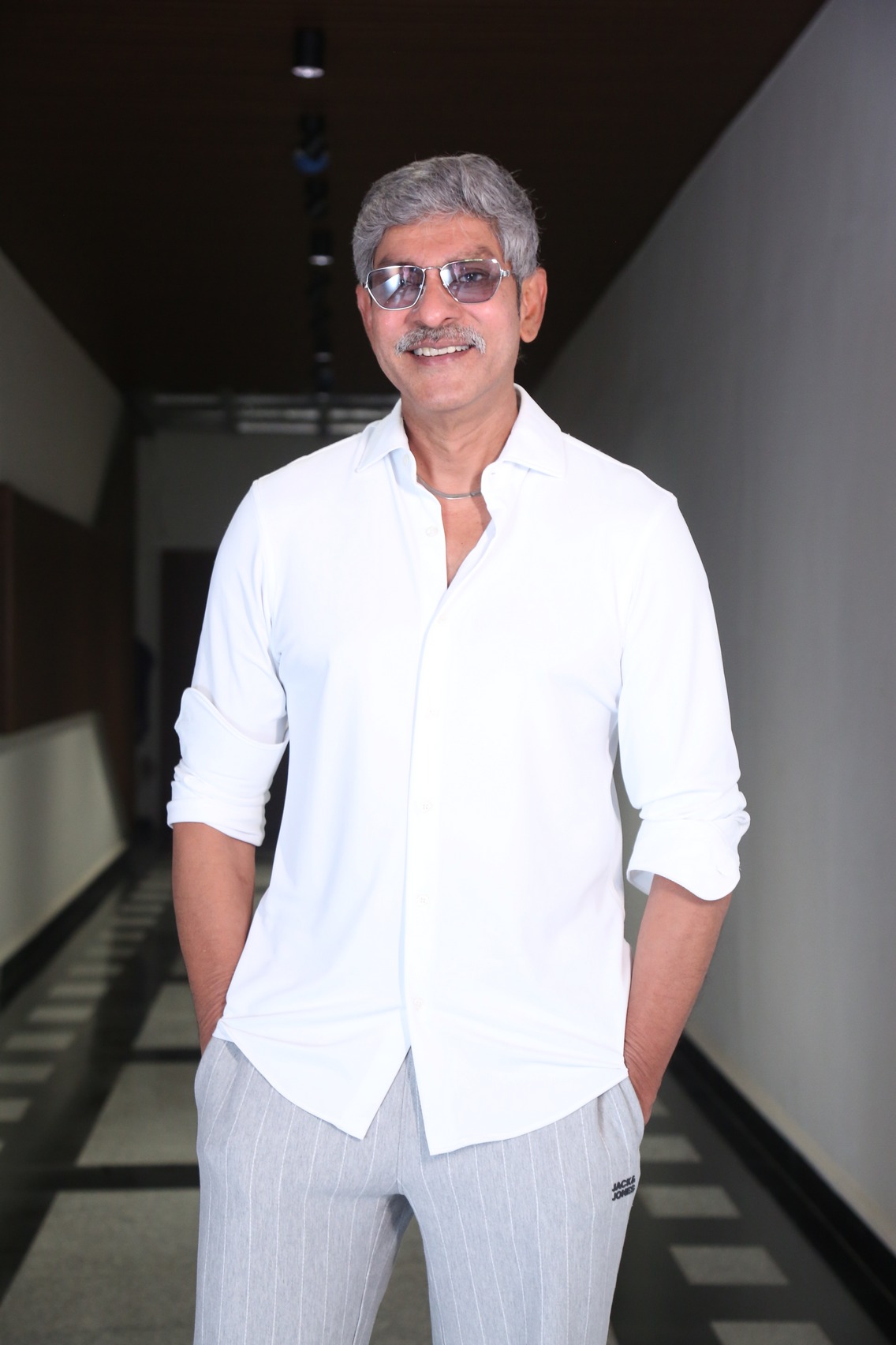 Jagapathi Babu in a neatly styled white ensemble showcasing a confident and polished appearance