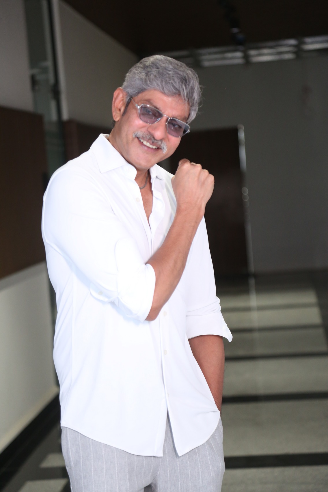 Jagapathi Babu in white outfit with gray hair, representing sophistication and timeless appeal