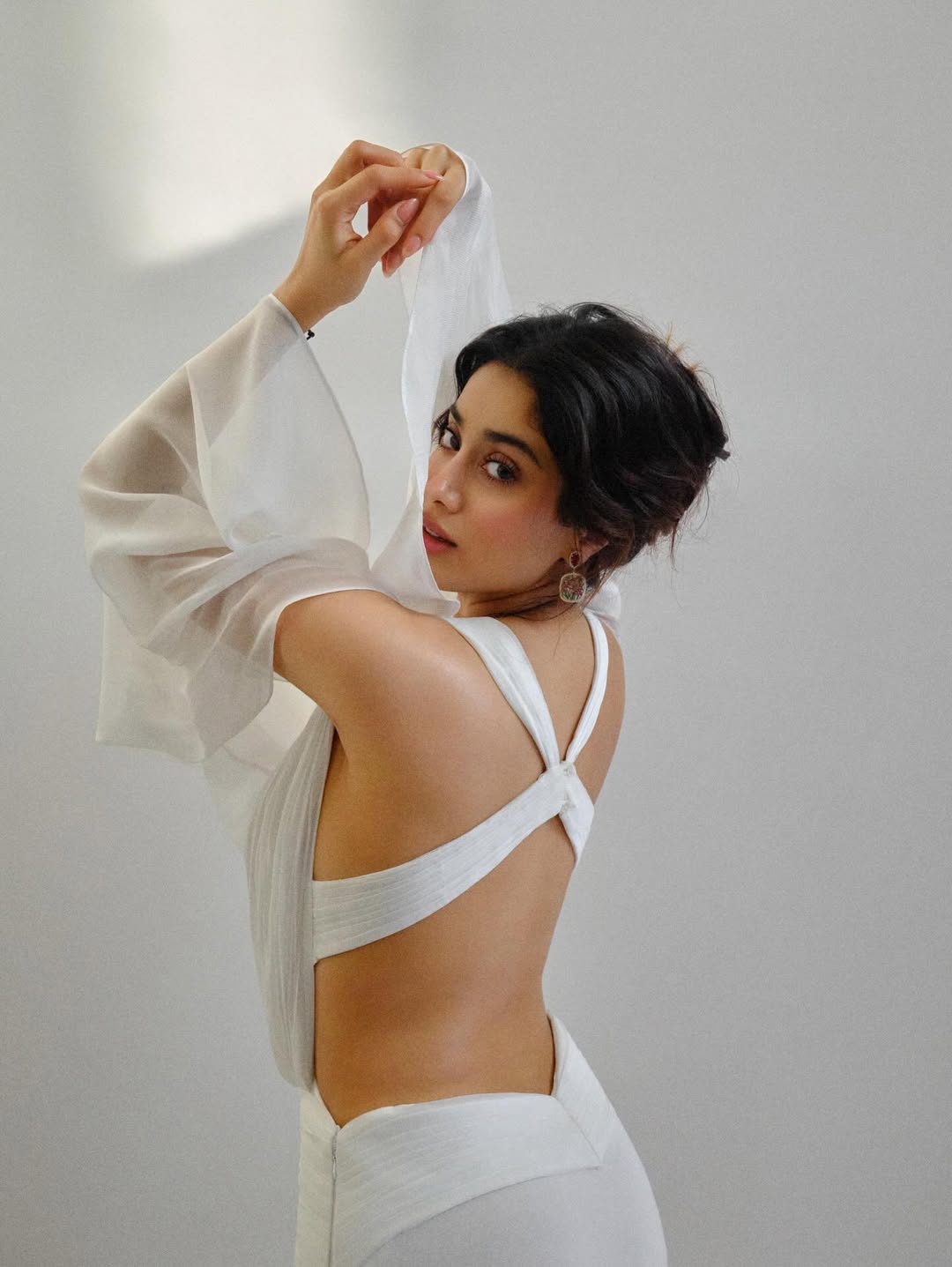 Janhvi Kapoor in a minimal white outfit showcasing clean lines and subtle detailing.