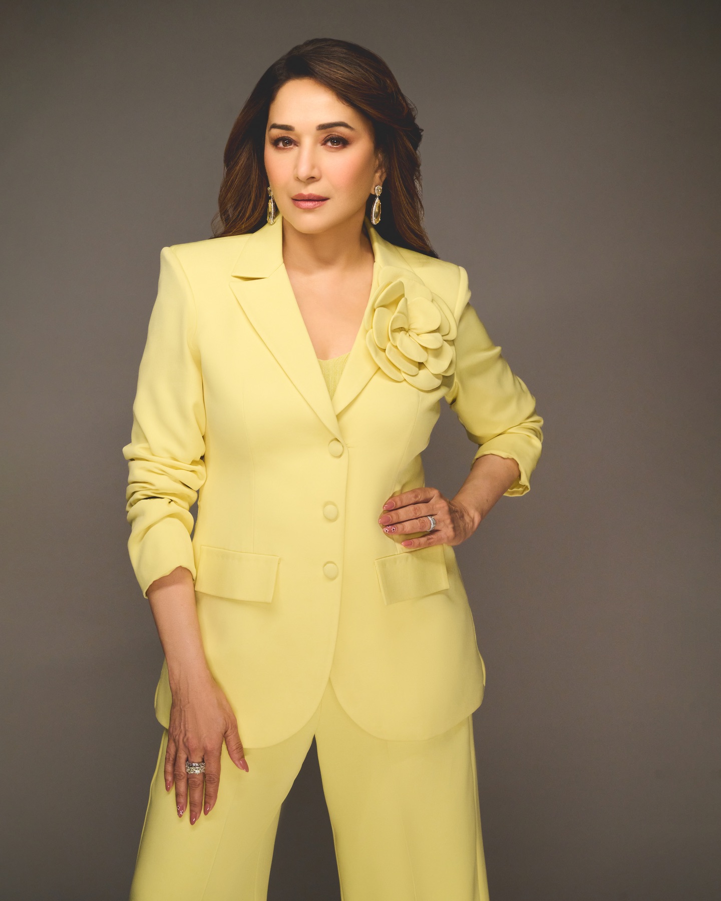 Madhuri Dixit in viral photoshoot wearing vibrant yellow power suit trending online