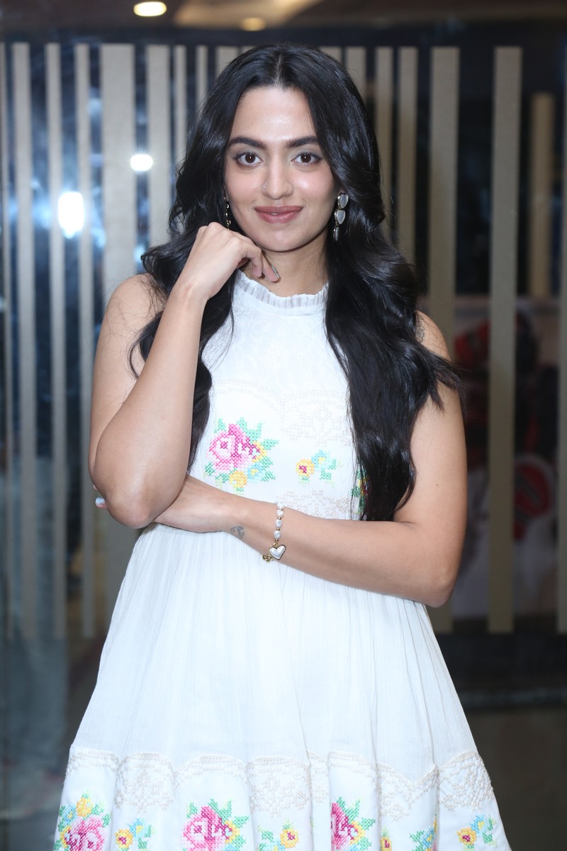 Malvika Nair showcasing a stylish dress with cross-stitch design elements