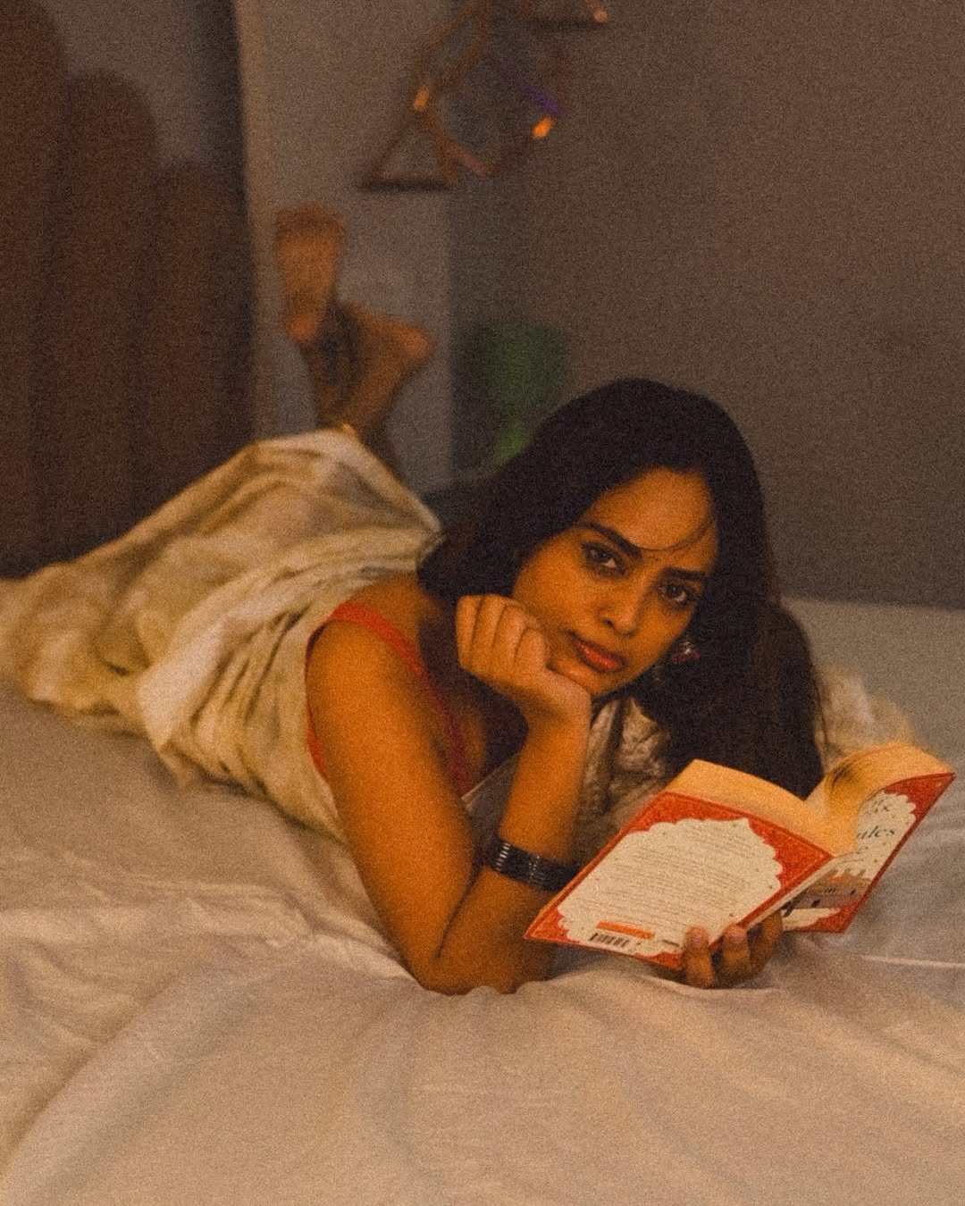 Nandita Swetha reading book in stylish pose