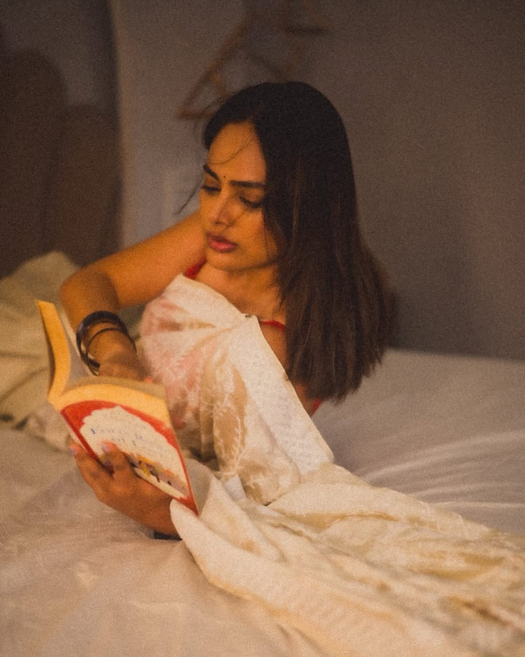 Nandita Swetha enjoying reading in saree look