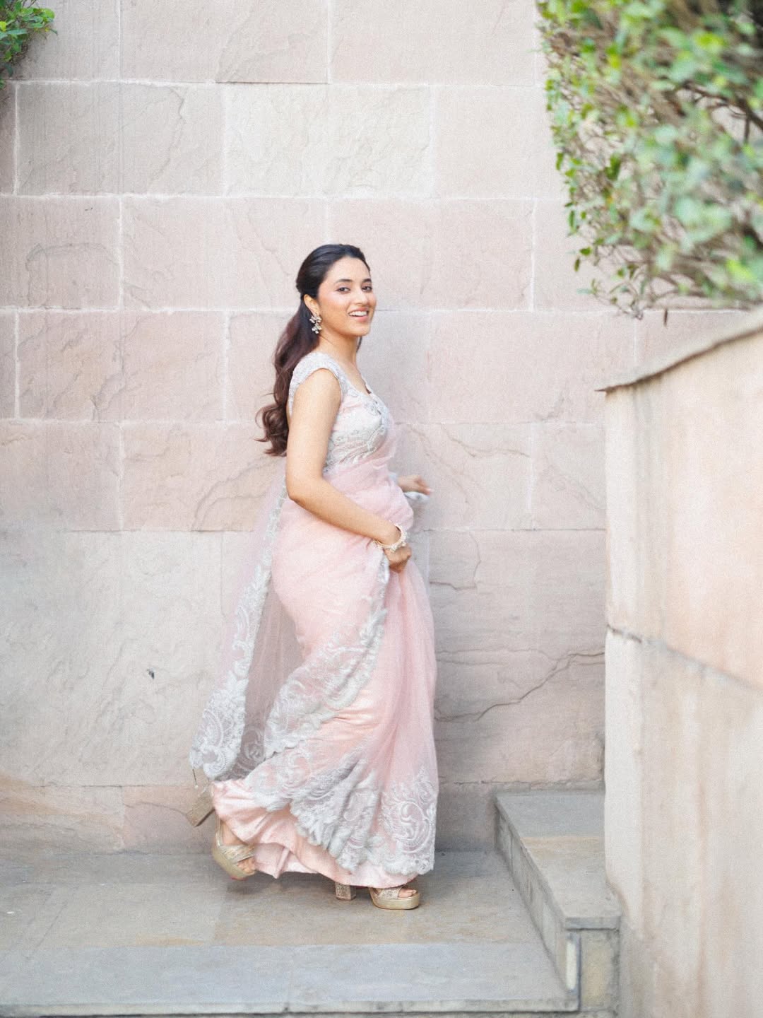 Priyanka Mohan pastel pink saree glamorous stair pose