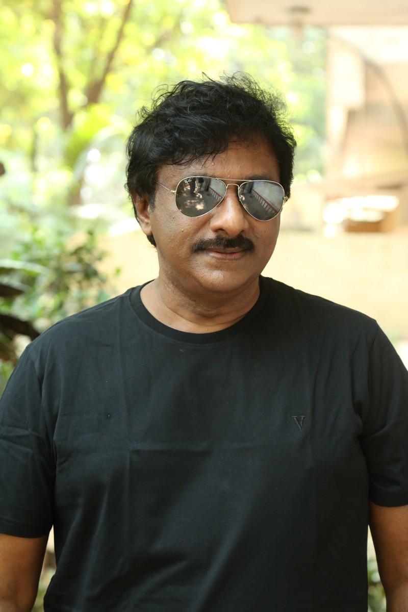 Raghu Kunche black tee tousled hair stylish pose