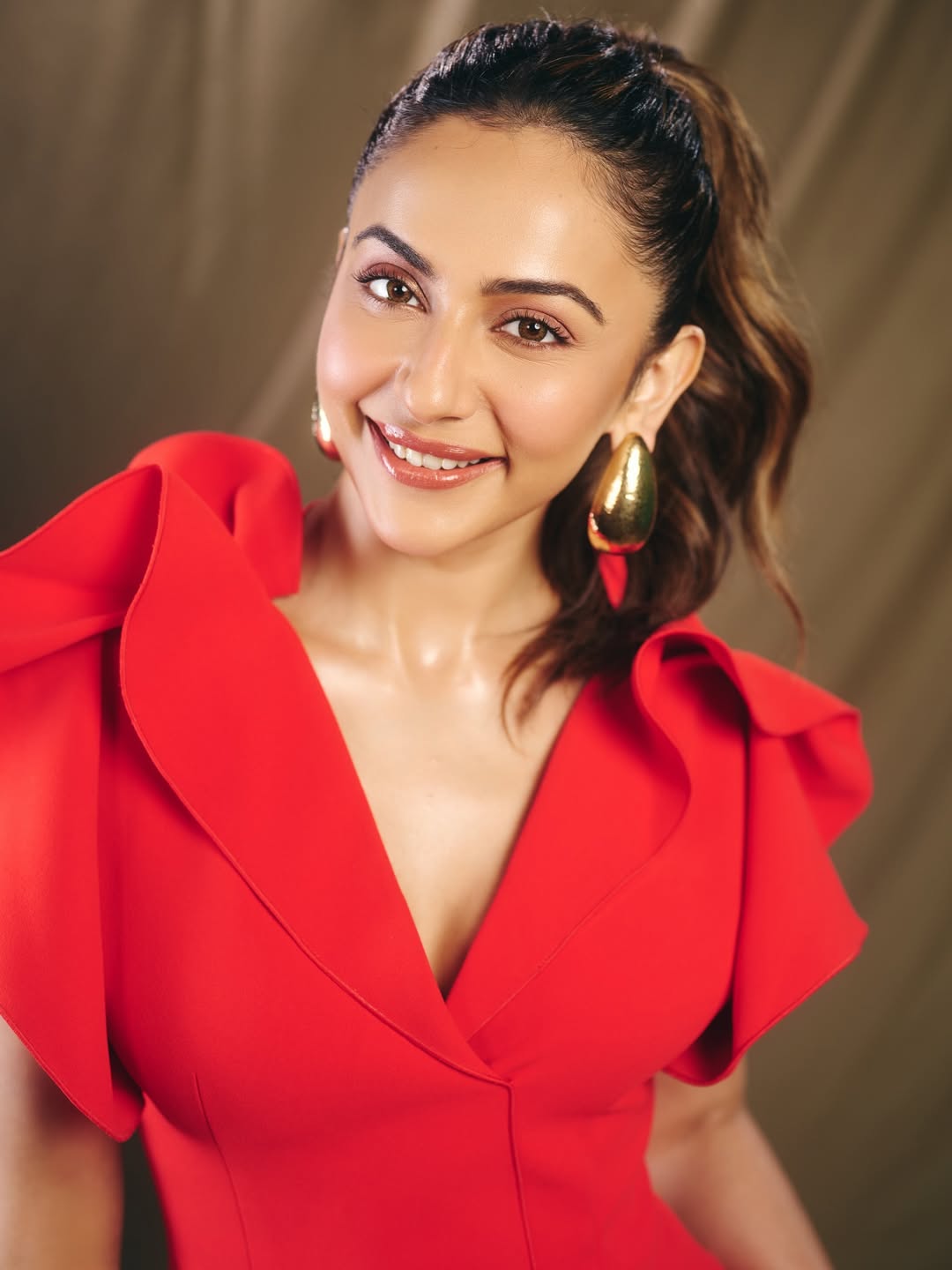 Rakul Preet Singh in sculpted red high fashion dress